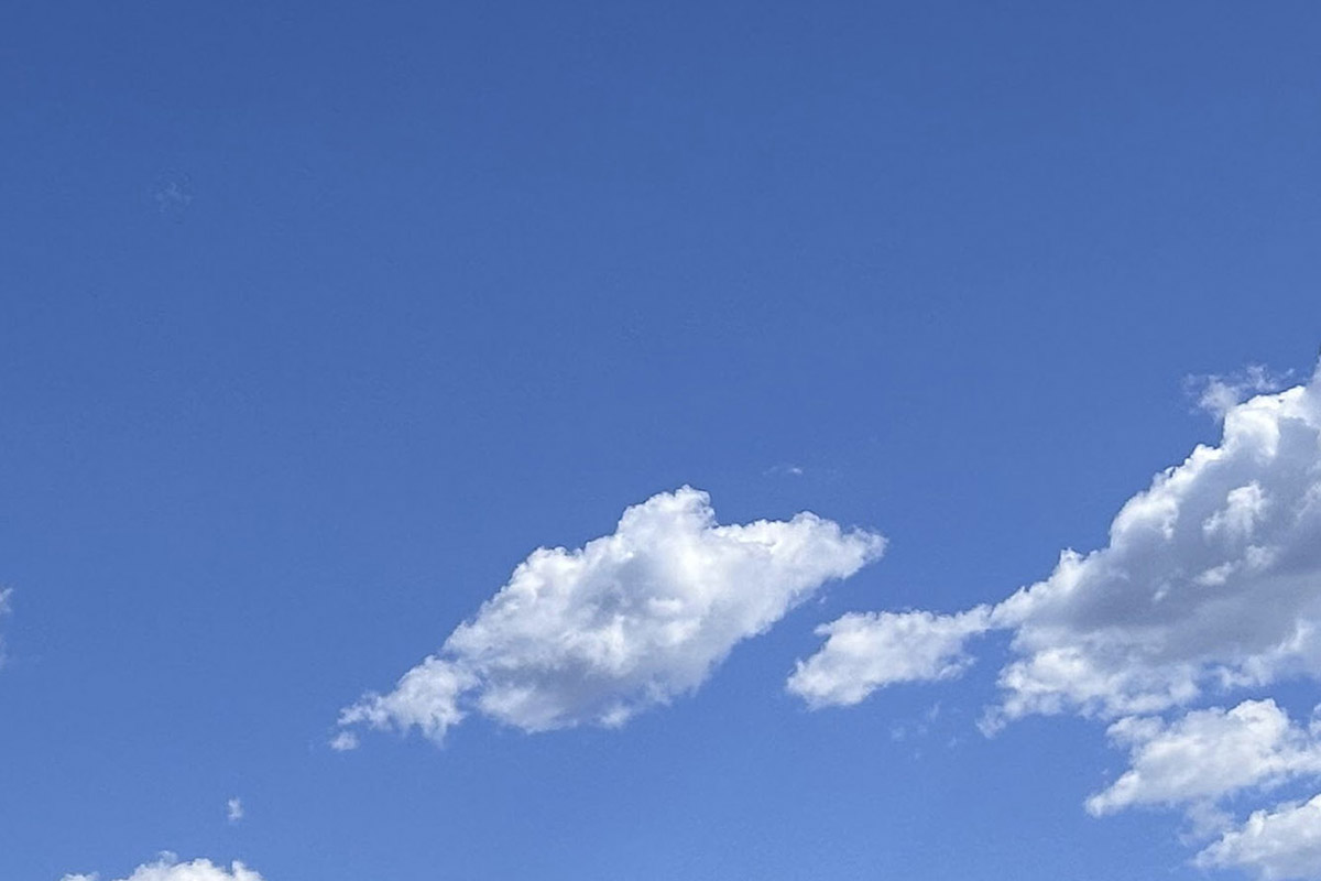 Clear blue sky with small clouds
